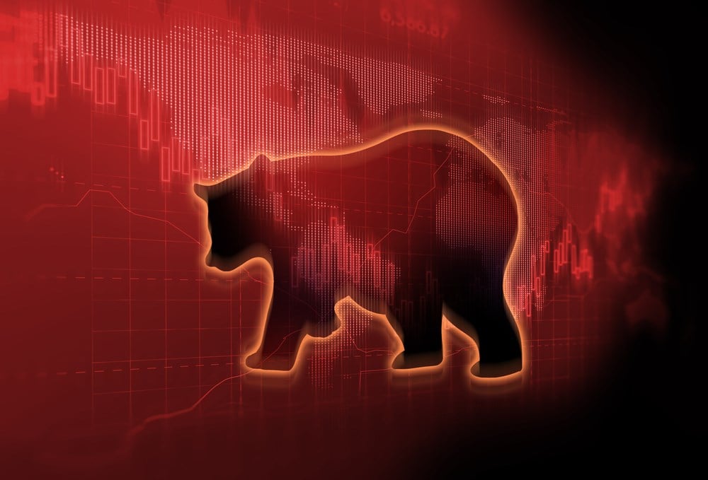 silhouette form of bear on financial stock market graph represent stock market crash or down trend investment; learn 
